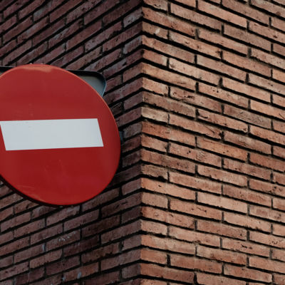 red and white signage on red brick wall